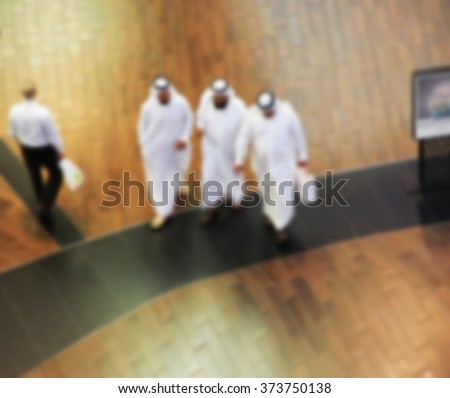 Arab sheikhs man in a mall make a purchase, Dubai, people go to the mall, market, blurred for backgroundd Royalty-Free Stock Photo #373750138