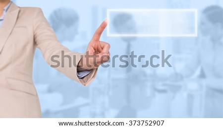 Businesswoman pointing against blue background