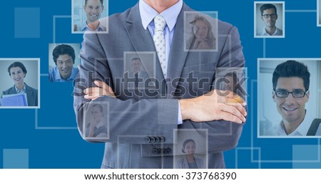 Midsection of businessman standing arms crossed against royal blue