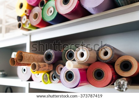 a lot of colorful rolls of wrapping paper. Showcase of shop