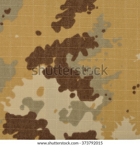 The texture of the textile material camouflage. Closeup photography. Without color correction