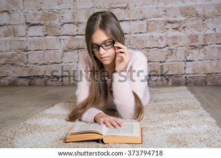 Beautiful girl reading book.  Soft photo of girl with old book. education and school concept - little student girl studying and reading book at school