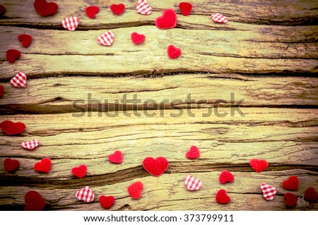Small red hearts putting on wooden background