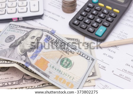 Dollar cash and calculator on business documents background