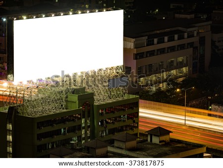 blank billboard in the night time for advertisement. long exposure makes long street light tails.