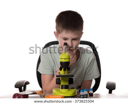 boy teenager Looking Through Microscope isolated on white background