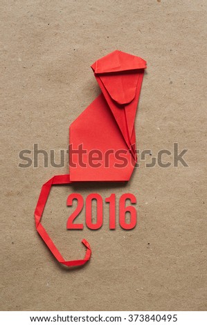 Folded paper origami monkey on red eco background. 2016 vertical postcard template.