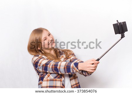 Girl have fun with selfie stick 
