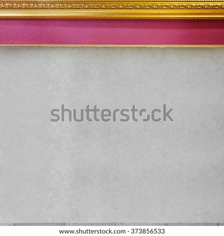 Background wall gray color texture have picture frame gold color on top under is pink color