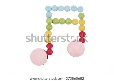 multicolored macaron chocolate candy musical note on white background