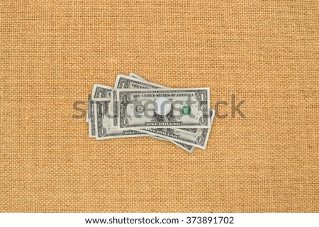 US Dollars Hanging Tacked to Canvas Board Background