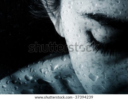 Young woman behind the glass with the drops of rain Royalty-Free Stock Photo #37394239