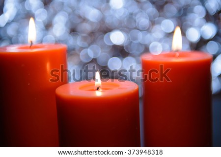 three big aromatic candle light up in front of beautiful bokeh background, valentine's day