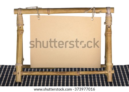 empty frame for a photo from a bamboo on a dark support and the isolated background
