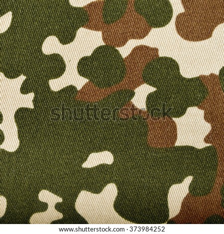 The texture of the textile material camouflage. Closeup photography. 