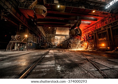 Pouring of liquid metal in open-hearth furnace Royalty-Free Stock Photo #374000293