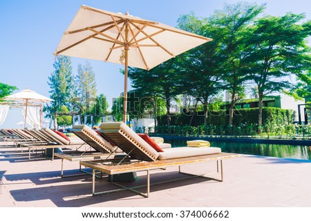 Umbrella pool and chair in beautiful luxury hotel pool resort - Filter Processing style pictures