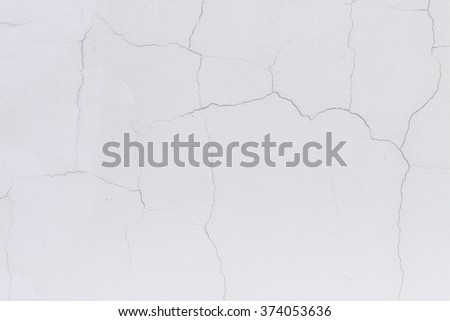 plastered white wall with cracks