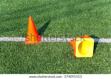 Agility cones on on soccer field background
