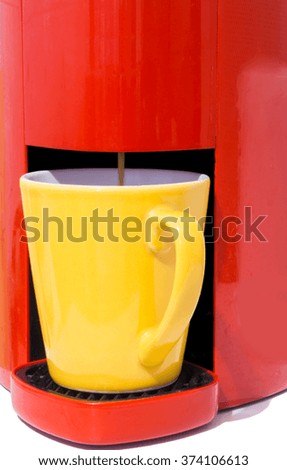 picture of yellow cup that is filled in coffee from machine