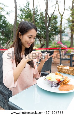 Woman taking photo of her waffle 