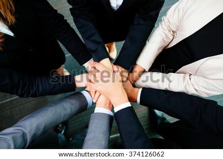 Overhead picture of business people joining hands