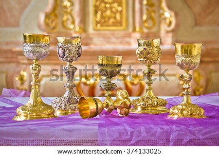 Golden holy grails on church altar view, religious equipment