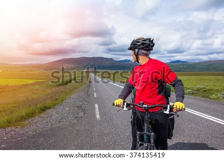 Happy biker ride on road in Iceland. Travel and sport picture
