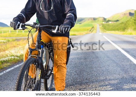 Happy biker ride on road in Iceland. Travel and sport picture