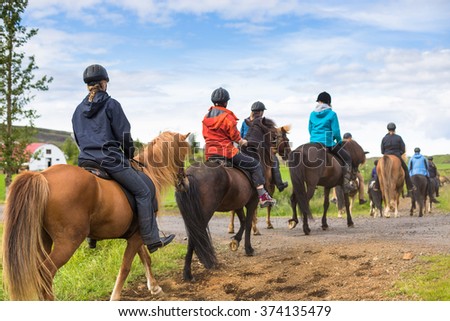 Group of horseback riders ride  in Iceland Royalty-Free Stock Photo #374135479