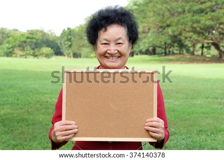 Portrait of Asian senior holding board