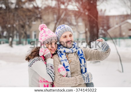 couple in love making selfie on winter picnic at park