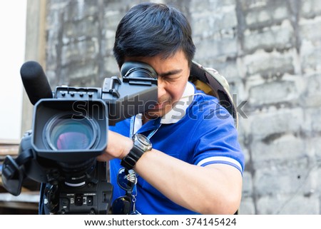 The cameraman filming outdoor event