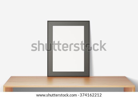 Blank picture frame on a wooden table, mock up