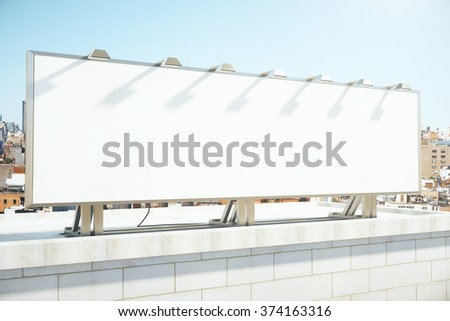 Large blank billboard on a building roof, mock up