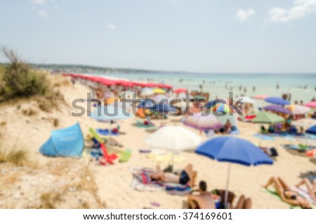 Defocused background of a crowded beach in Salento, Apulia, Italy. Intentionally blurred post production for bokeh effect