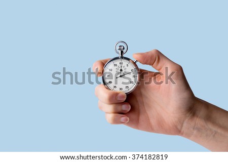 timer held in hand, blue background Royalty-Free Stock Photo #374182819