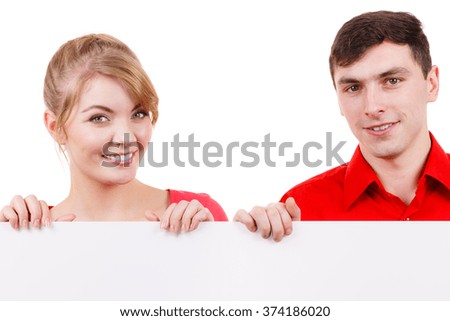 Couple with blank presentation board. Woman and man showing banner sign billboard copy space for text. Advertisement concept. 