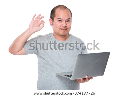 Man use of laptop computer and ok sign gesture