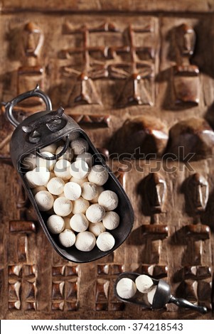 kurt kurut - asian dried yogurt balls on carved wooden background