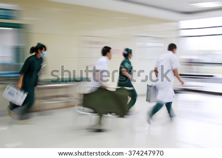 Health care workers rushed past emergency treatment hall, closeup of photo
