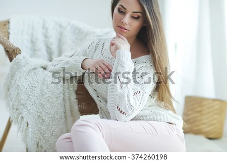 Beautiful woman in a sweater at home