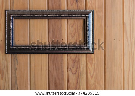 Blank frame on wood wall 