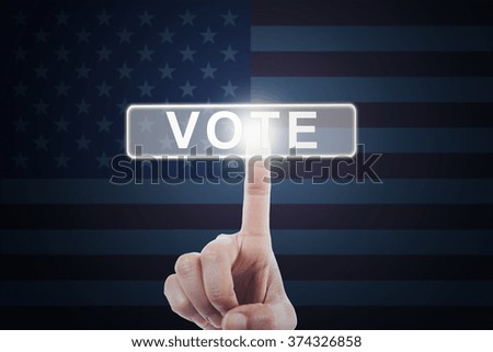 Picture of hand pressing a vote button on the futuristic screen with american flag background