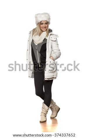 young beautiful woman in winter clothes posing in studio
