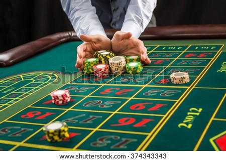 Picture of a green table and betting with chips. 