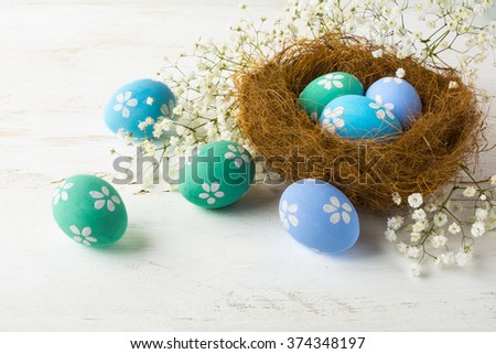 Hand-painted Easter eggs in the nest. Pastel colored Easter eggs. Easter background. 