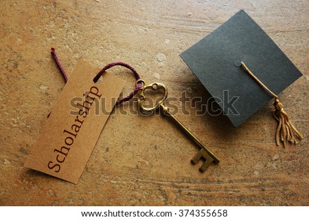 Gold key with Scholarship tag, with graduation cap                                Royalty-Free Stock Photo #374355658