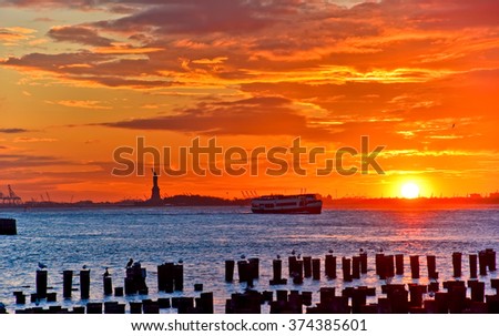 View of the Statue of Liberty at sunset in New York City. 