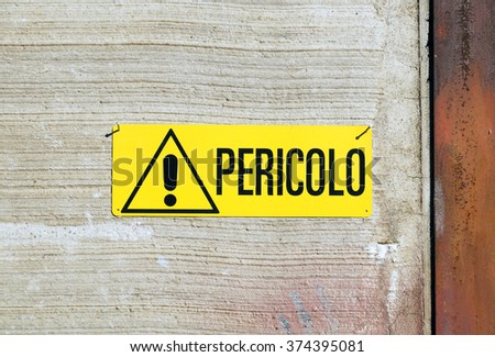 industrial danger sign . In Italian language "pericolo" means danger